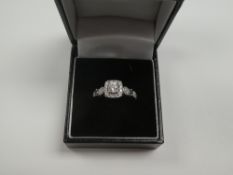 Vera Wang; An 18ct white gold diamond dress ring ring by Vera Wang 'Love' ring set with central roun