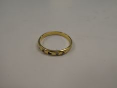 Unmarked yellow gold, possibly 18ct gold band ring inset four small diamonds, one missing, unmarked,