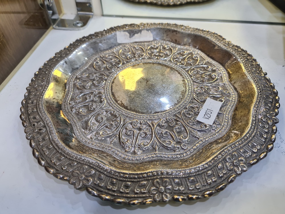 A Ceylonese repoussed dish, Sri Lanka, in the shape of the Island. Engraved and having foliate embos