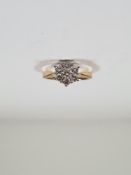 18ct yellow gold diamond cluster ring in the form of a flower head on raised claw mount, marked 750,