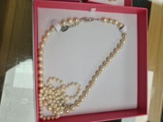 Carrie Elspeth; a boxed as new simulated pearl necklace, bracelet and matching earrings