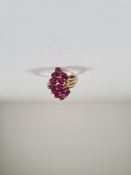 Contemporary 10K yellow gold dress ring set with two rows oval mixed cut rubies in asymetric mount,
