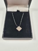 9ct white gold fine neckchain hung with a 9ct gold square pendant inset with diamond chips
