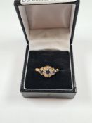 Antique 18ct yellow gold dress ring set with 3 pale blue sapphires the central stone surrounded 8 ro