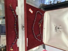 Isle of Wight pearl; a cased 9ct gold clasped garnet and amethyst necklace, earring and bracelet set