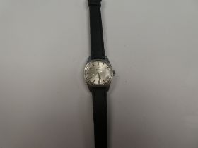 Omega; A Stainless steel Omega Geneve wristwatch with silvered dial and baton markers, on black leat