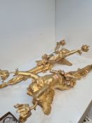 A pair of reproduction gilt 2 sconce wall lighters of cherub with arms aloft, 72cm
