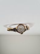 9ct yellow gold cased ladies watch with golden guilloche numbered dial marked 375, on expanding 9ct