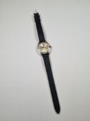 Omega; A Stainless steel Omega Geneve wristwatch with silvered dial and baton markers on black leath