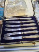 A cased set of silver handled knives hallmarked Sheffield possibly 1914 John Biggin. Also with some