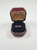Antique 18ct yellow gold ruby and diamond trilogy ring, with central round cut ruby and a brilliant