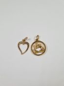 Two 18ct yellow gold pendants, one a circular example depicting two kneeling figures holding branch
