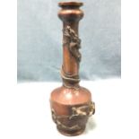 An eastern bronze vase, the tubular neck with entwined clawed dragon beneath a bowl shaped rim,