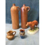 A pair of German earthenware gin bottles with moulded loop handles; a continental porcelain model of