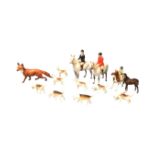 A Beswick collection - huntsman with eight hounds, mounted lady master, pony club girl on piebald, a