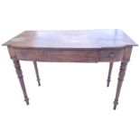 A nineteenth century breakfront mahogany side table, with single-piece deep shaped top above three