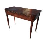 A nineteenth century mahogany turn-over-top tea table inlaid with ebony stringing above a plain