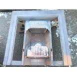 A late Victorian cast iron fire insert with moulded decorative band framing apertures for tiles, the