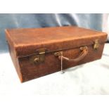 An Edwardian crocodile skin travelling case with fitted lined interior having brass mounts -