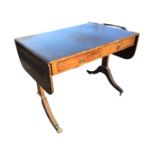 A reproduction mahogany sofa table inlaid with ebony stringing, with rounded drop-ends and two