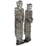 A pair of lifesize Eastern antique carved hardwood figures with original painted decoration, each