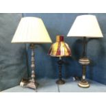 A tall silver plated tablelamp with baluster column and pleated shade, raised on triangular base
