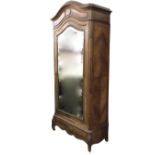 A C19th French walnut armoire with arched moulded cornice above a tablet frieze with central oval