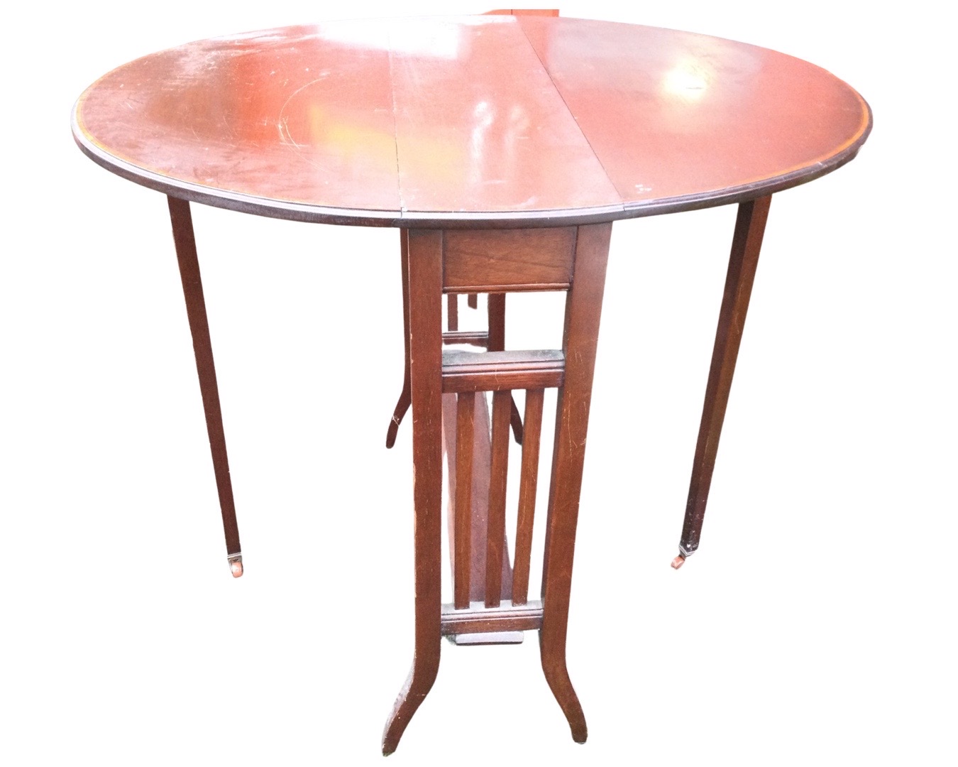 An Edwardian mahogany sutherland table with satinwood crossbanding to oval top, having drop-leaves