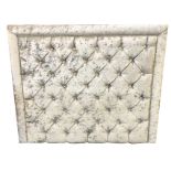 A contemporary silvered button upholstered headboard with deep studding and crystal cut glass