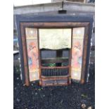 An art nouveau cast iron fire insert with foliate scroll embossed hood framed by figural and
