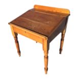 A Victorian pine desk with cleated hinged lid enclosing an interior with two small drawers, raised