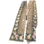 A pair of floral printed cotton curtains with borders of flowers framing panels with deer and