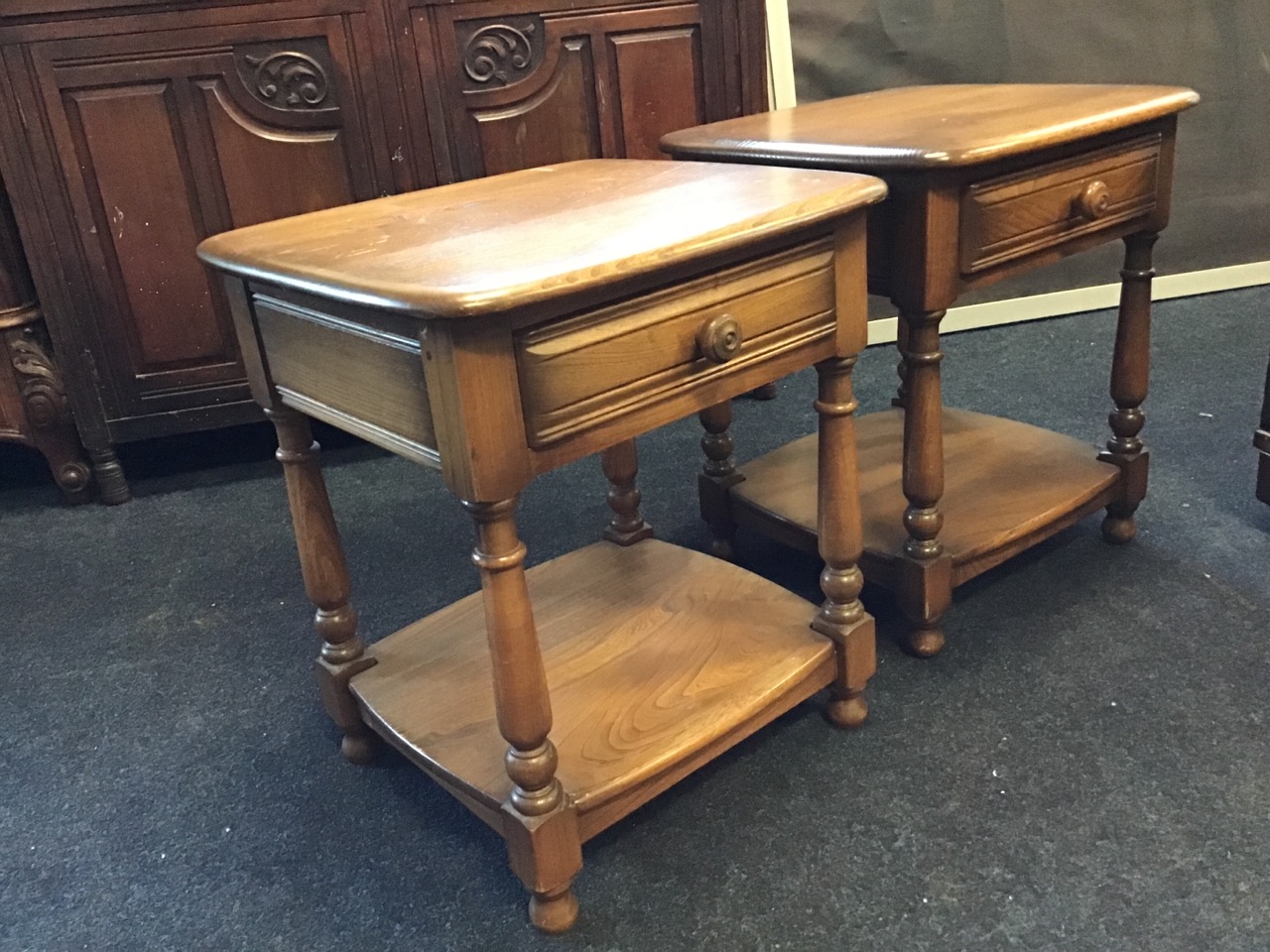 A pair of Ercol elm bedside tables with square rounded tops above ribbed frieze drawers, raised on - Image 2 of 3