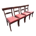 A set of four nineteenth century mahogany dining chairs with shaped bar backs above scroll carved