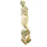 A composition stone statue of a draped lady hiding her modesty, raised on chamfered plinth,