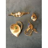 Three contemporary yellow metal hinged pin brooches - a brushed leaf with oval jade type stone, a