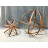 A graduated pair of rusty slatted globe spheres. (19in x 13.5in) (2)