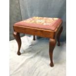 A square mahogany stool with floral tapestry needlework to drop-in seat, the plain rails supported