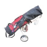 A cased set of Ben Sayers golf clubs in bag, complete with folding trolley.
