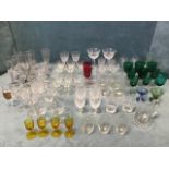A collection of early drinking glasses - sets, a toasting glass, custard type cups, an engraved