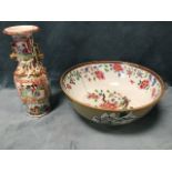 A circular nineteenth century Chinese famille bowl decorated in the traditional pink palette, with