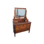 A mahogany dressing table with bevelled mirror in rectangular frame above two small drawers, the