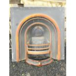 A Victorian style cast iron fire insert with arched moulded aperture. (37in x 37in)