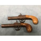 A pair of nineteenth century percussion cap pocket pistols with octagonal barrels and hardwood