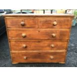 A Victorian pine chest of drawers mounted with knob handles, with two short and three long