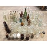 A collection of “dug-up” antique glass bottles and jars including medicine bottles, storage pots,