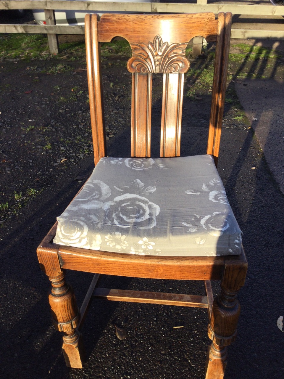 A set of three oak chairs with scroll carved backs and cushion seats, raised on turned legs joined - Image 3 of 3