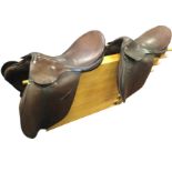 A leather saddle by Giddens of New Oxford Street, WC1; and another leather general purpose