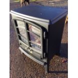 A Dimplex electric stove with faux coals behind glazed doors, raised on angled feet. (17.5in x 11.