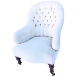A Victorian style button upholstered spoon-back armchair with serpentine shaped sprung upholstered